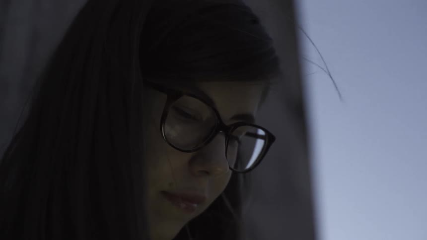 A young woman looking down at something