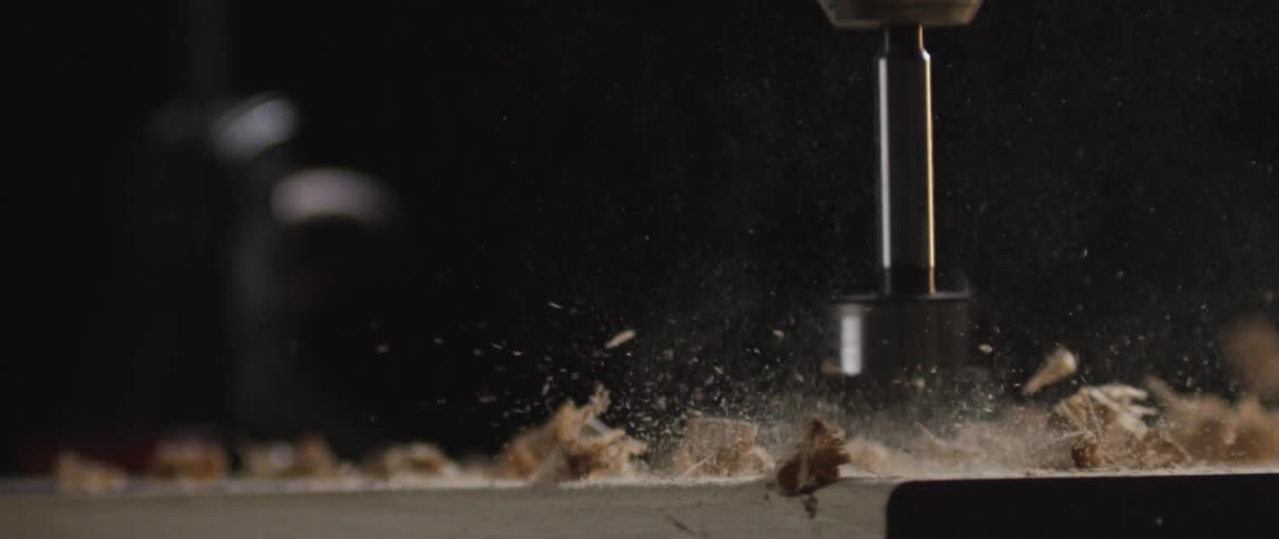 A person is drilling into a piece of wood