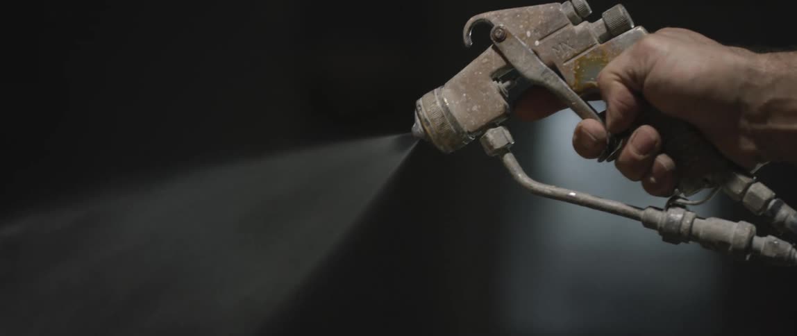 A man sprays a pressure washer