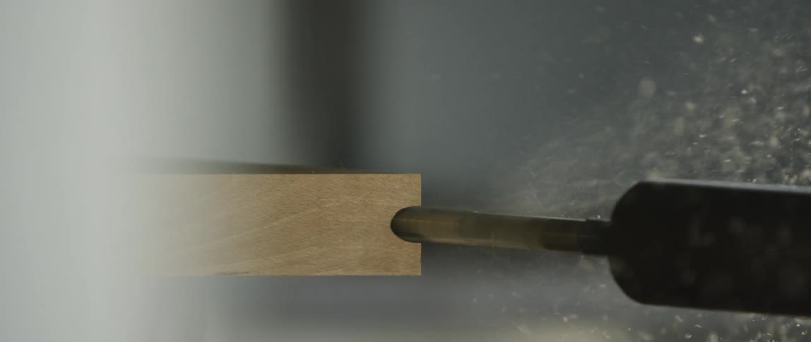 A tool is cutting through a piece of wood