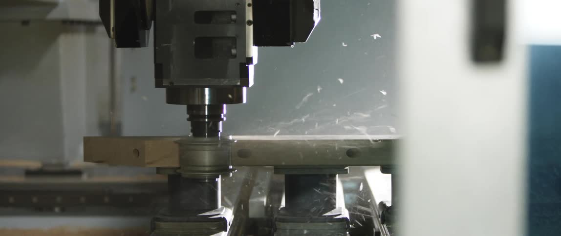 A machine shaving wood in a factory