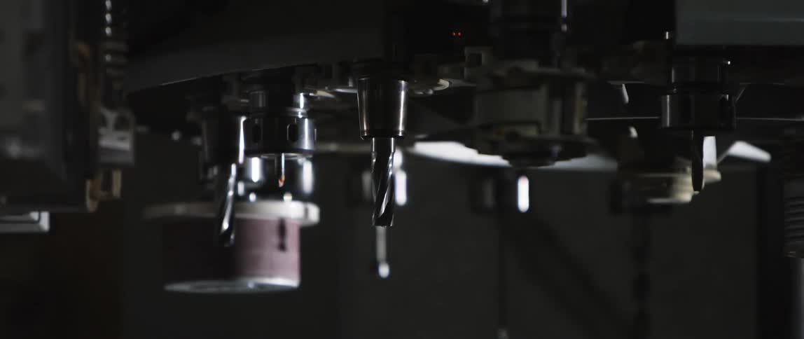 Various robotic machinery moves and spins in a factory