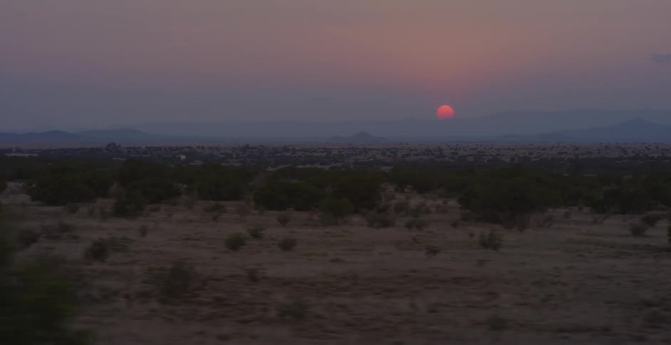 The sun is setting in the horizon