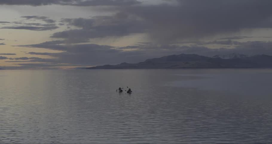 Kayak rowing in calm waters at sunset