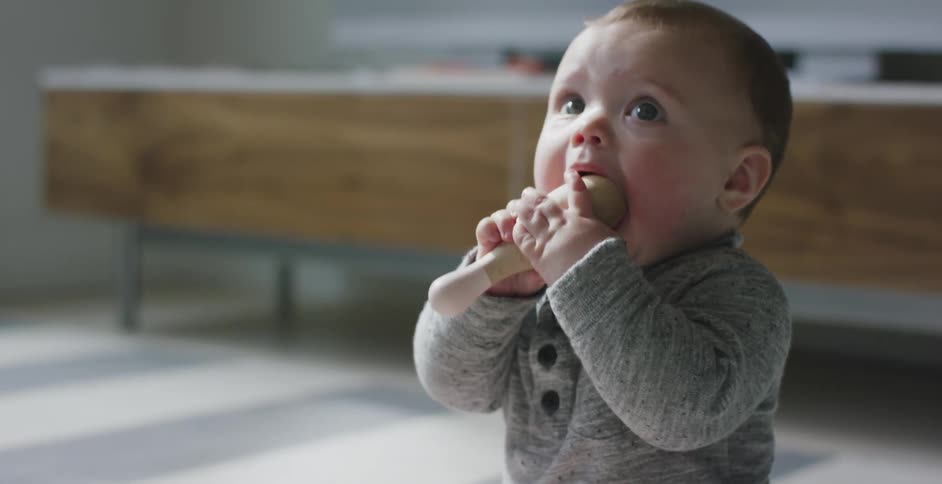 A child puts a small toy in his mouth