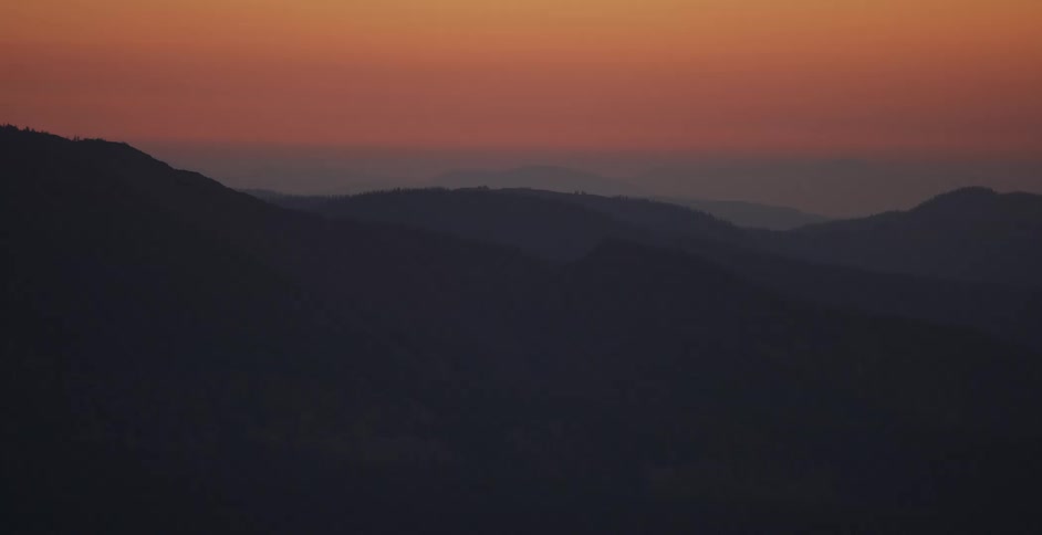 The sky is red above the mountains