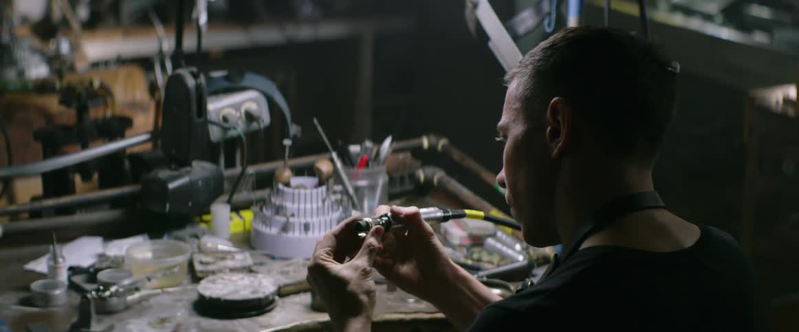 A jeweler polishes a ring