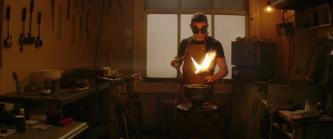 A man with safety glasses torches metal