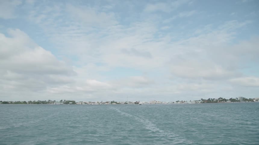 A lake with land and the sky in the background