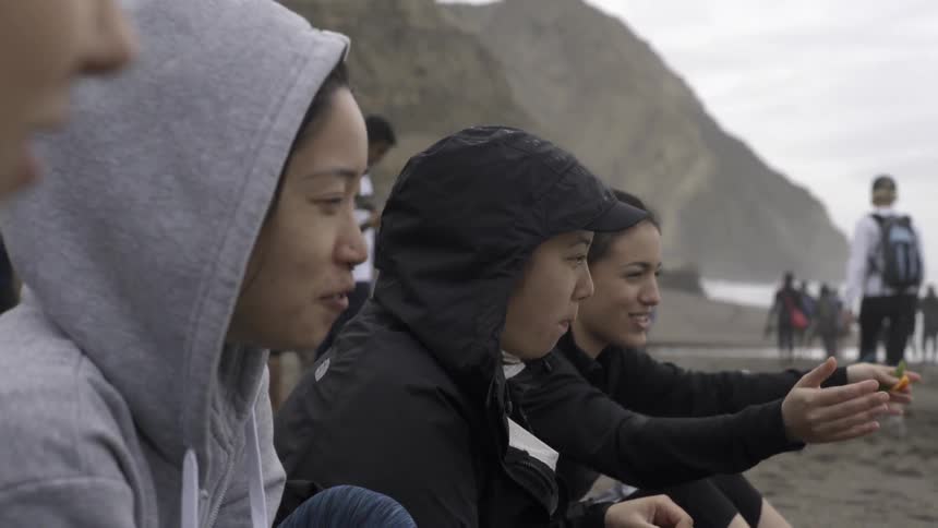 Group of girls hiking toward scenic Alamere Falls waterfall with joyful adventurous energy.