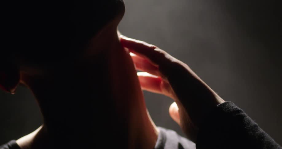 Silhouette of a woman on a dimly lit room