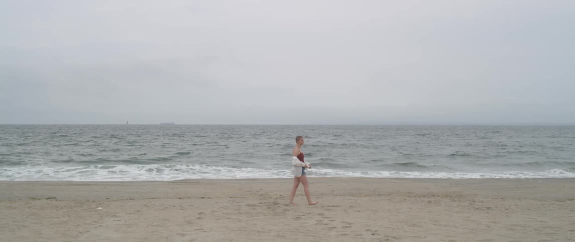 As woman walking on the beach
