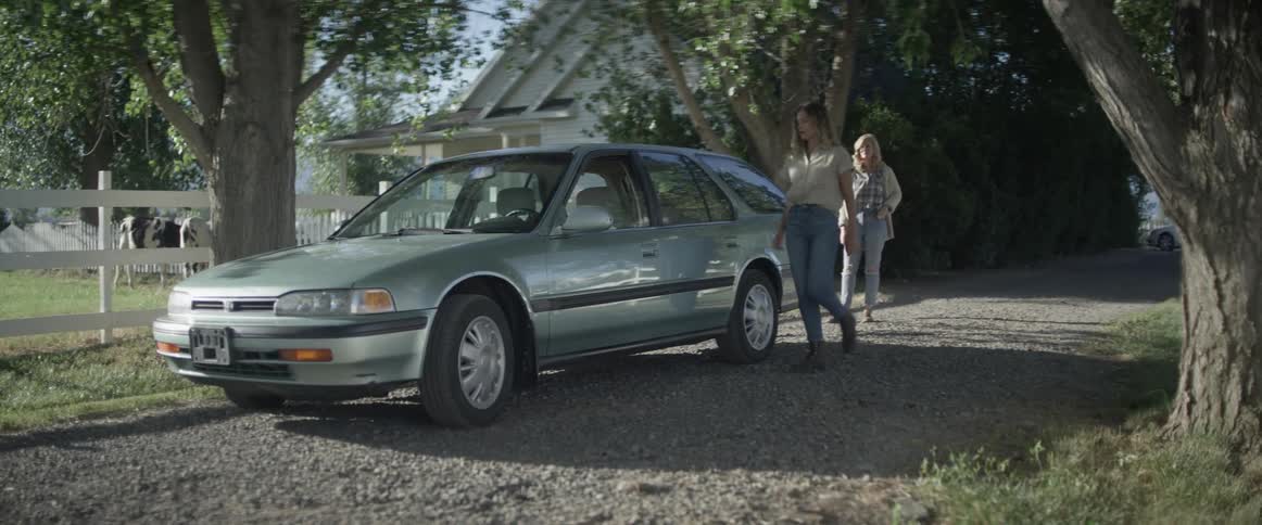 Two women hug then one woman walks towards a car and gets inside