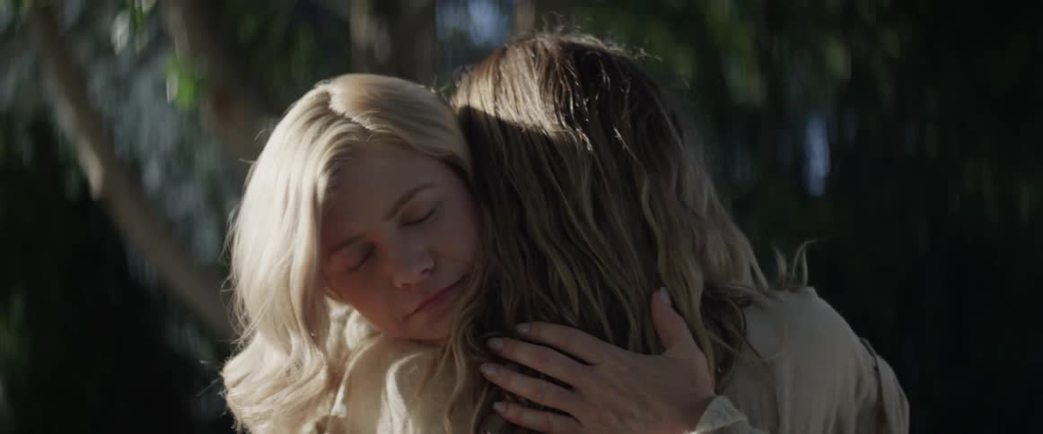 A mom and daughter hugging