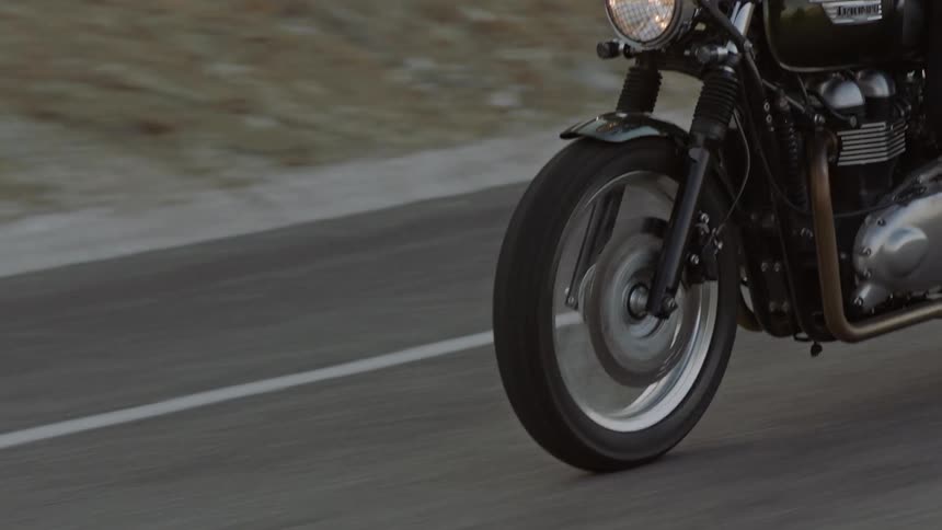 The motorcycle travels down the road
