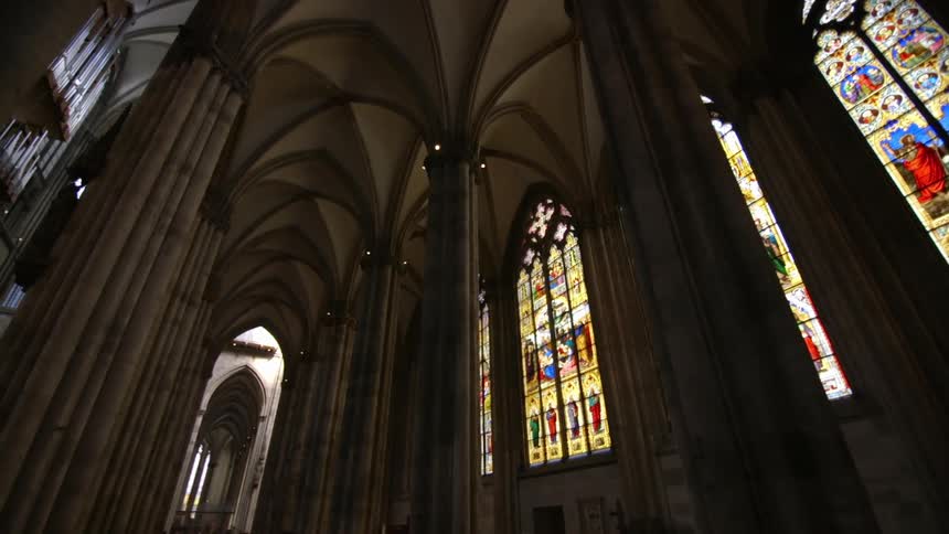 The sun lights up the stain glass windows in the church