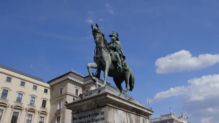 A statue of a man on a horse sits in front of the building