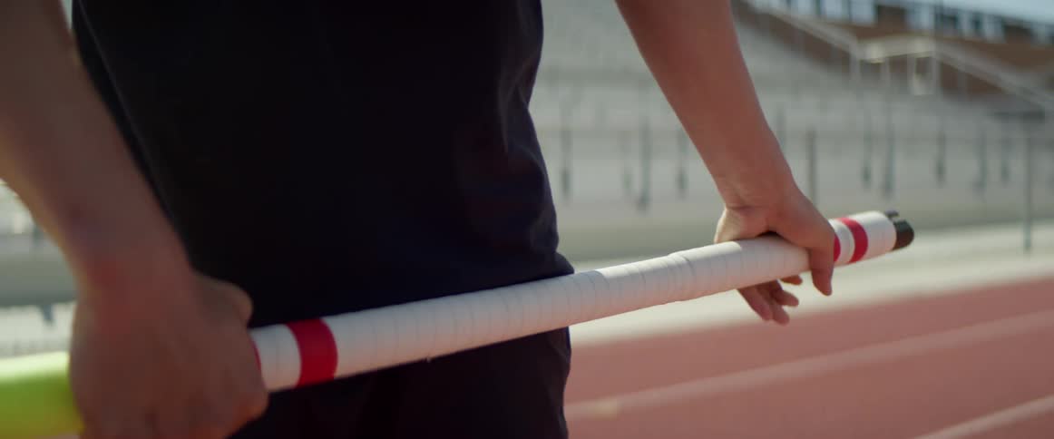 A man prepares to pole vault on a track