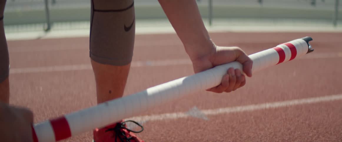 A man is exercising outdoors on a track