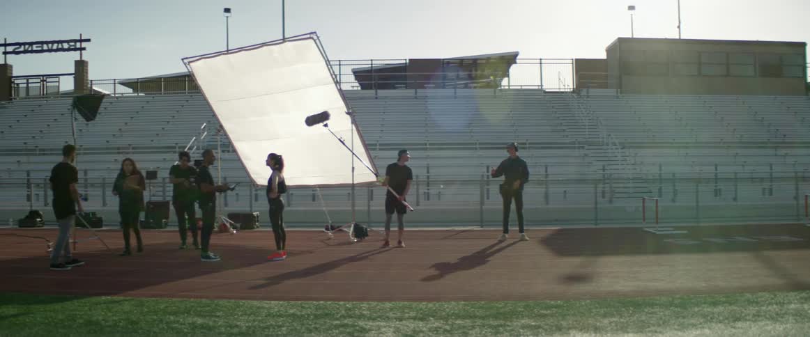 A teenager is interviewed on a track while it is being filmed