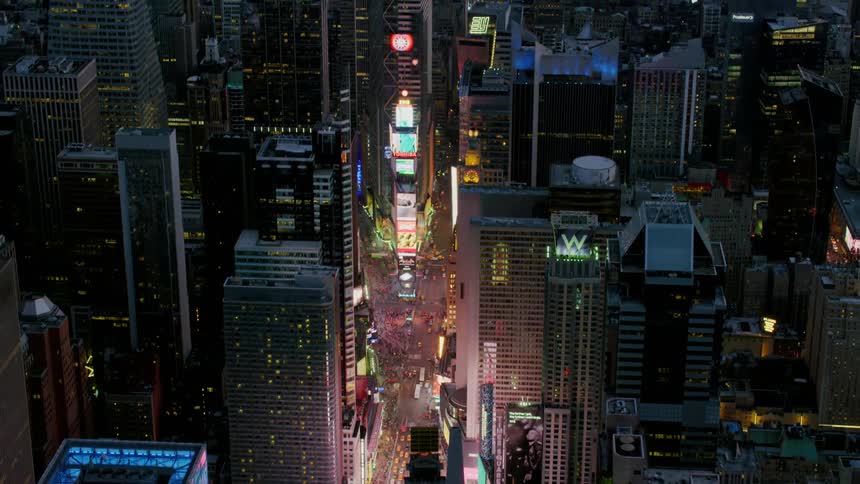 Times square is brightly lit at sunset