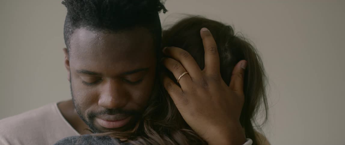 Man and woman hugging in living room