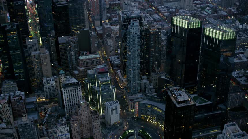 A downtown area of a city sparkles with lights at night