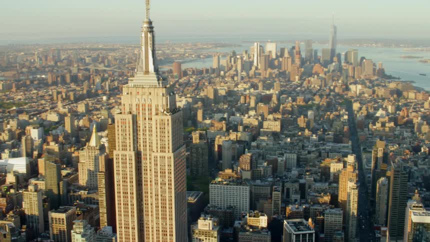 A skyscraper towers over a large urban downtown area