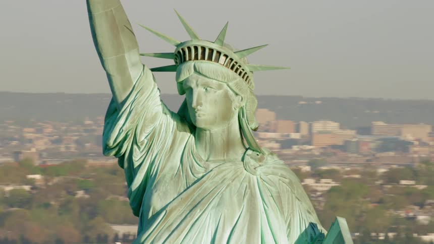 The statue of liberty with buildings in the background
