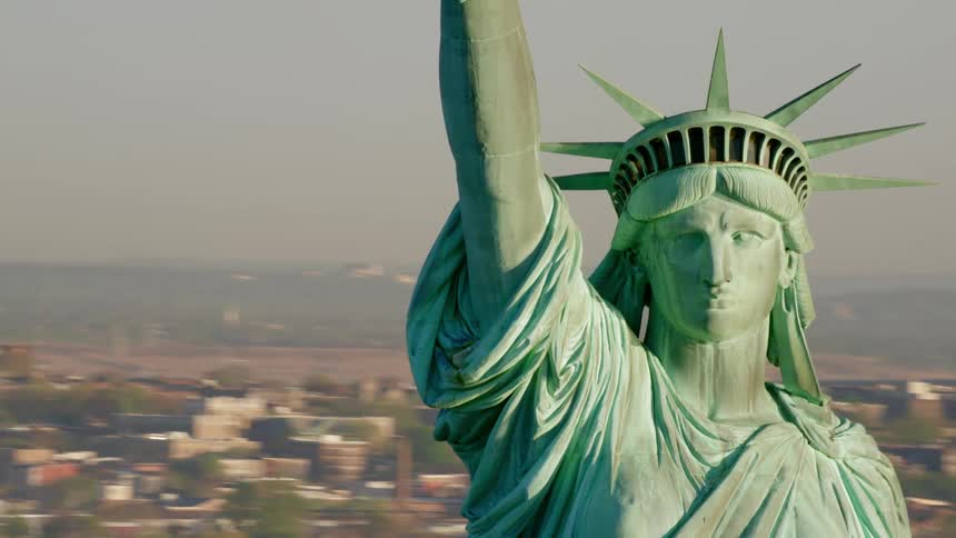 The statue of liberty with the skyline in the background