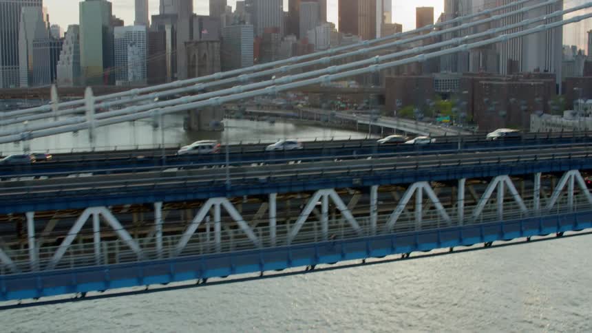 Cars are driving on a bridge over a body of water