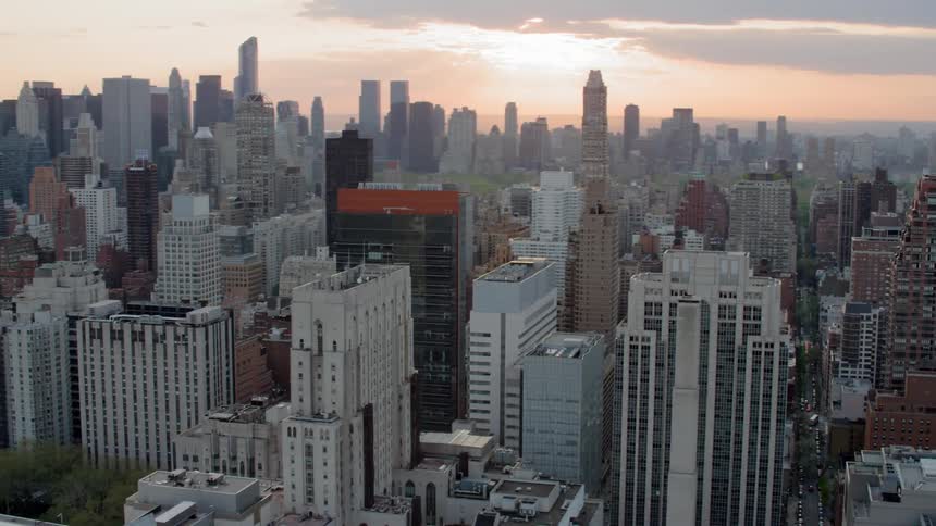 City buildings and skyscrapers sit in the city at dusk