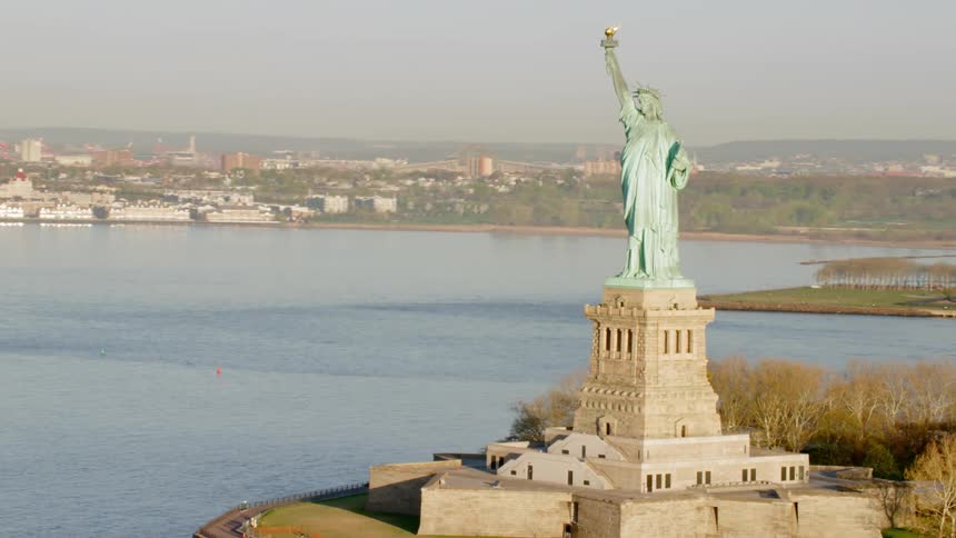 The statue of liberty with the water in the background