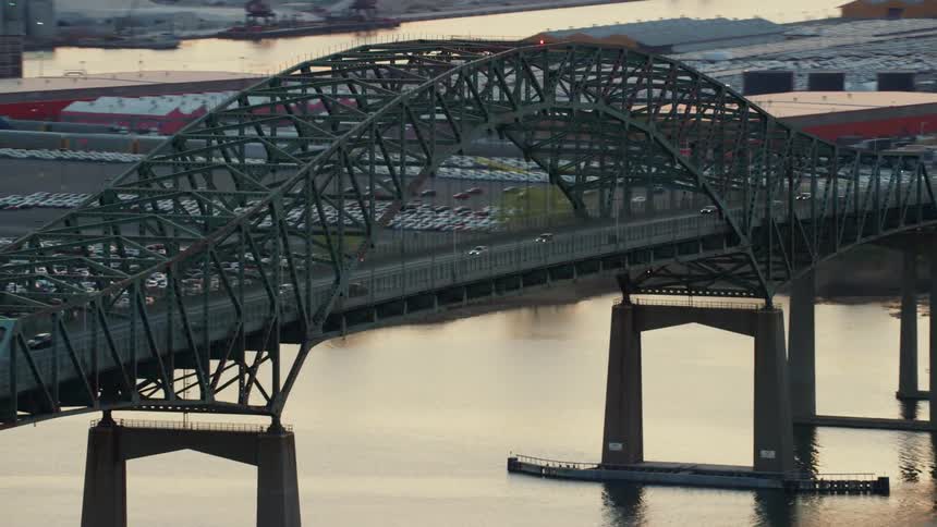 Traffic moves across a river on a bridge