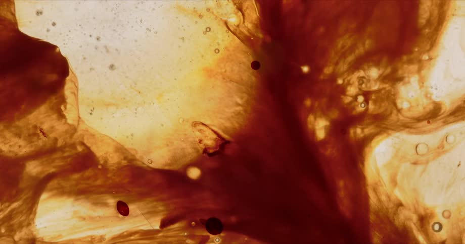 Brown fluids flow interspersed with bubbles