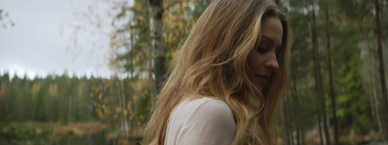 A woman is hiking in the woods