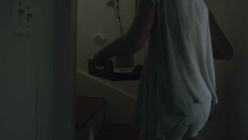 A woman carries a tray up some steps