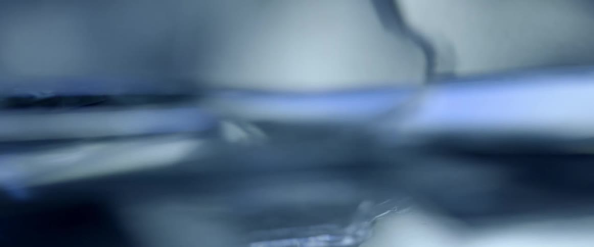 Sharp edges of broken glass are shown under a microscope