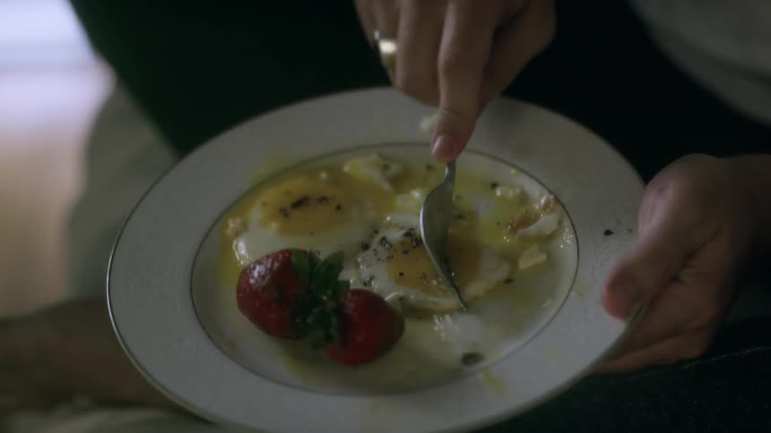 Someone eating eggs