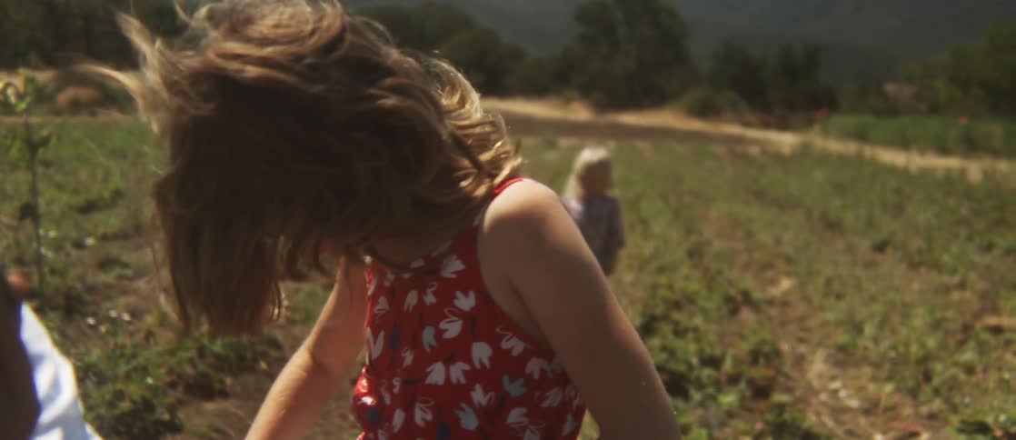 Two children put their face in a bucket as another carries one behind