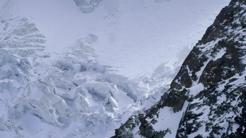 Steep cliffs and jagged rocks on mountain range covered in snow