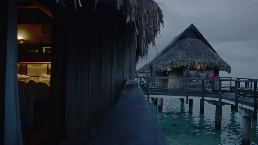 The water is clear under the huts on the pier