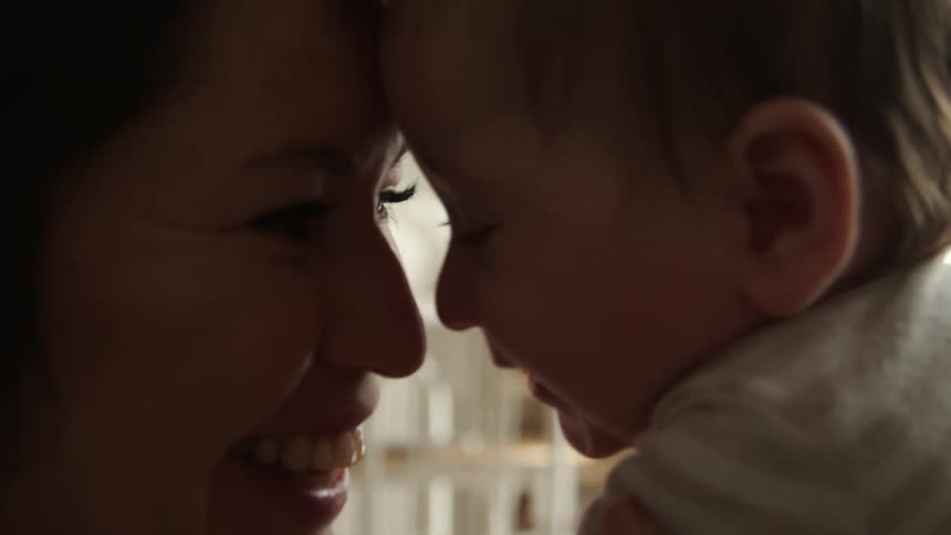 A woman playing with her baby