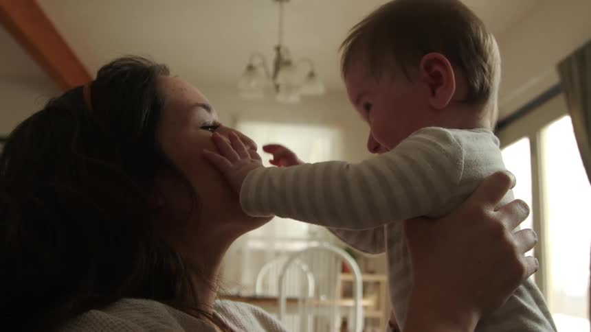 A woman playing with her baby