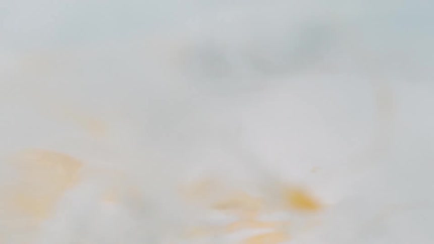An egg drops onto a cutting board covered with flour and explodes