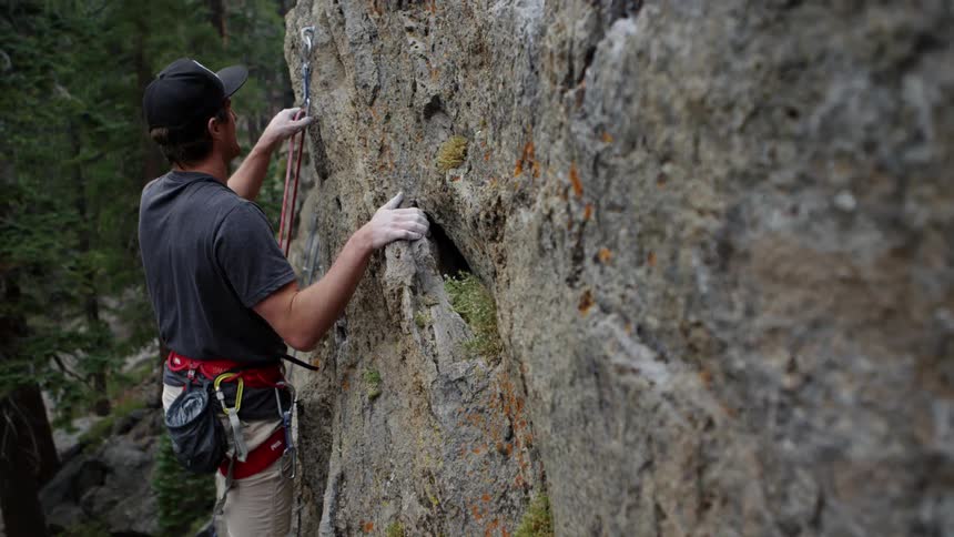 A man is climbing up a mountain