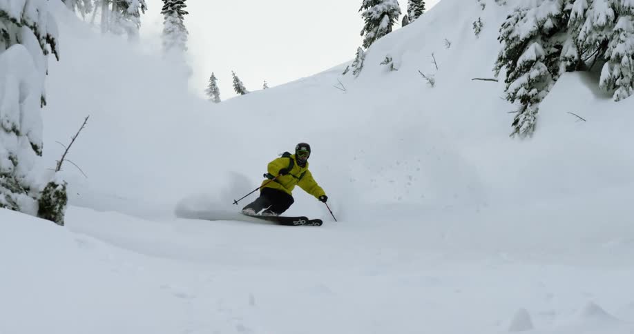A skier turns through deep powder