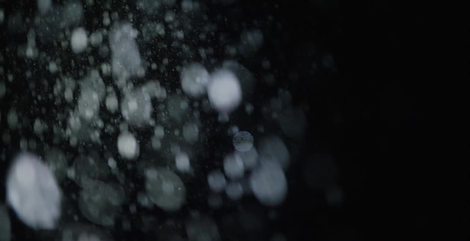 The snow is falling at night