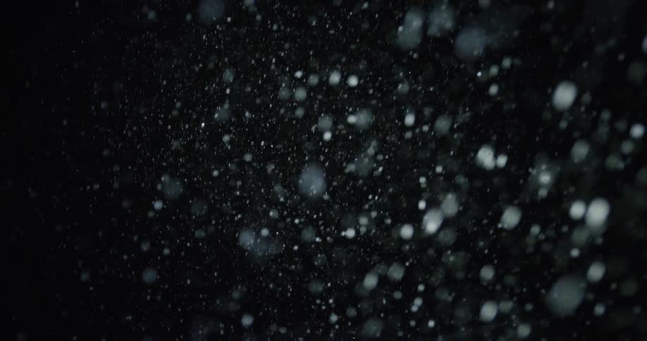 Snow falling on a black background