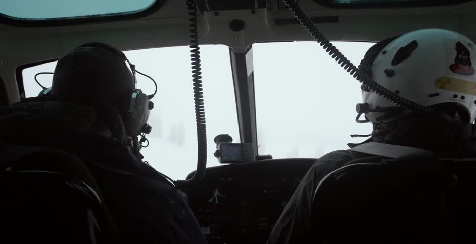 A pilot and a passenger in a helicopter